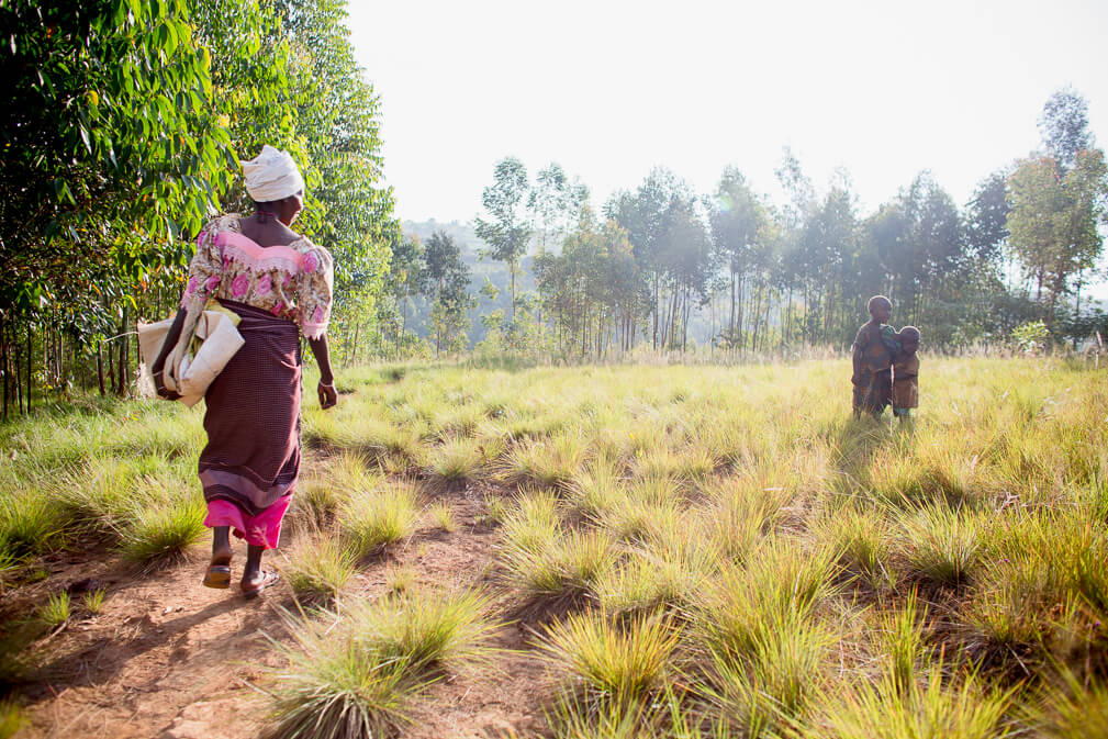 Burundian coffee farmer walking on a dirt path