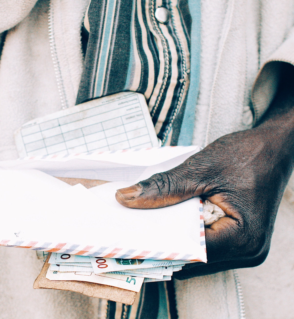 A person holding an envelope of money